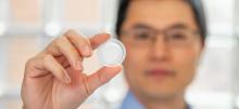 A photo of a scientist holding liquid nano foam inside a plastic pouch
