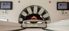 A person lying in a CT scan machine 