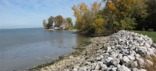 Autumn lakeshore with rocky embankment