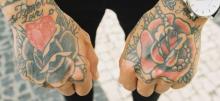 Two fisted hands showing off tattoos