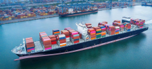 A large cargo ship carrying colorful shipping containers