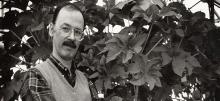 Chris Somerville posing near plants