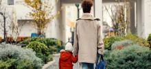 Person holding child's hand walking 