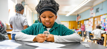 Little girl doing work in a classroom