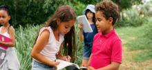 Group of children in nature with books