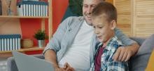 A son and father at a computer