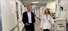 Kaylin Burton walking with person in hospital