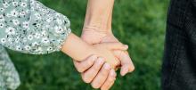 Person holding child's hand 