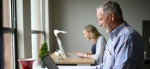 Two people using laptops