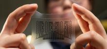 Person holding wearable technology thin transparent material