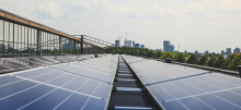 Solar panels with a city skyline in the background